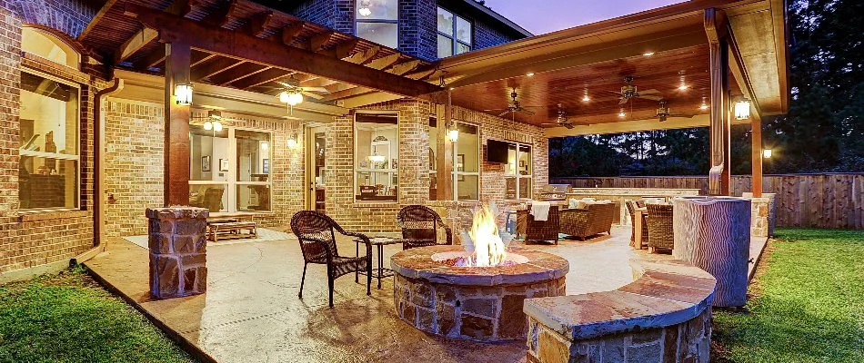 Patio area with a seating wall and fire pit.